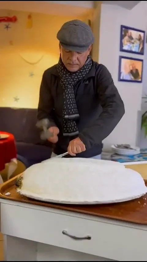 Video: fish baked in a salt crust on a tray, being cracked open with a hammer and knife