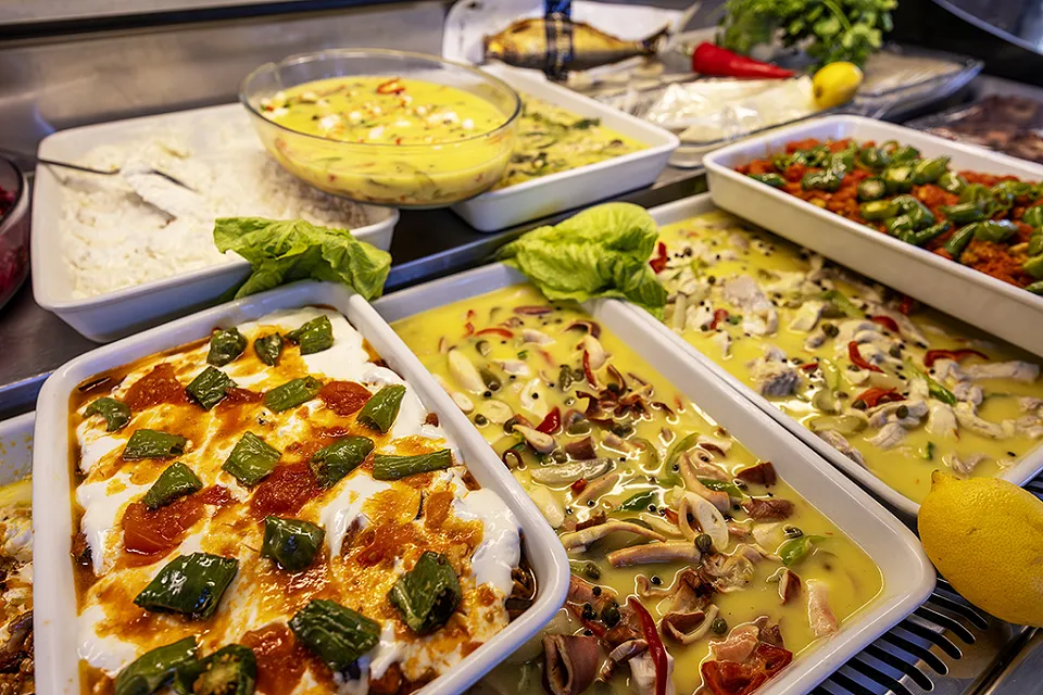 Trays of peppers with yoghurt, peppers with tomato and cold olive-oil meze in the meze display