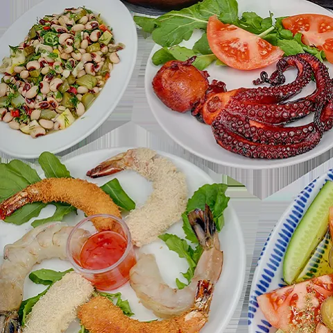 Seafood plates of grilled octopus and breaded prawns, served with black-eyed bean salad and rocket