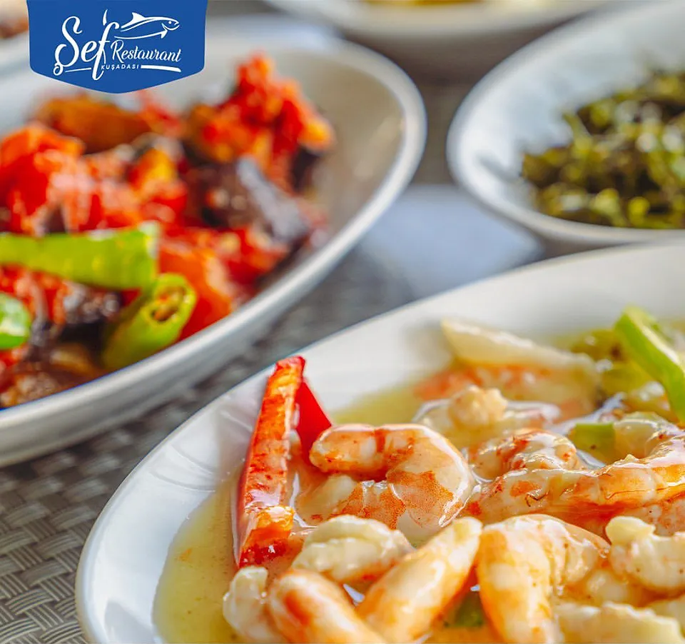 Prawns in a butter sauce, with a meze of aubergine with tomato and green peppers alongside